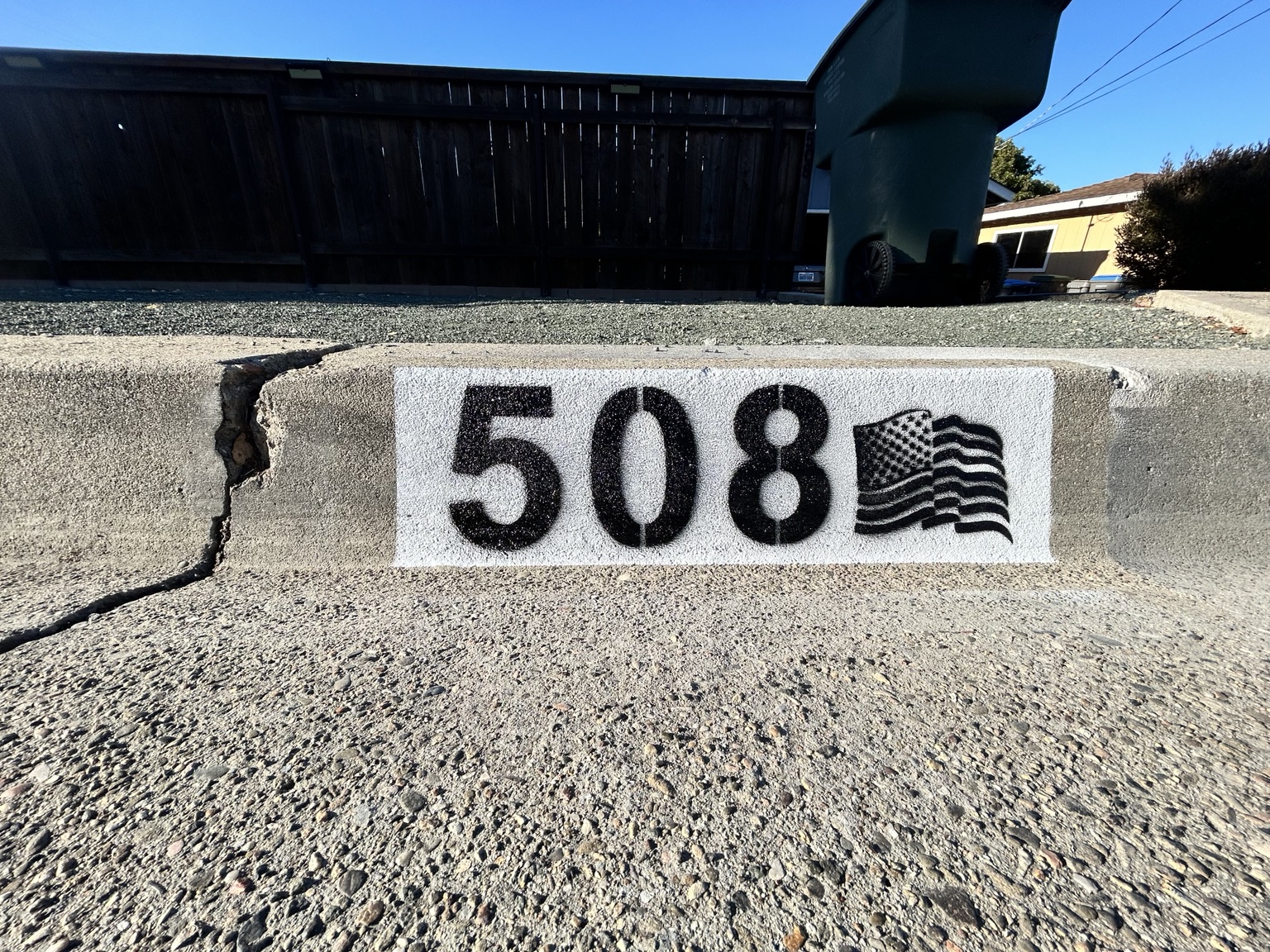 SloCurbs painted curb number 508 with an American flag icon